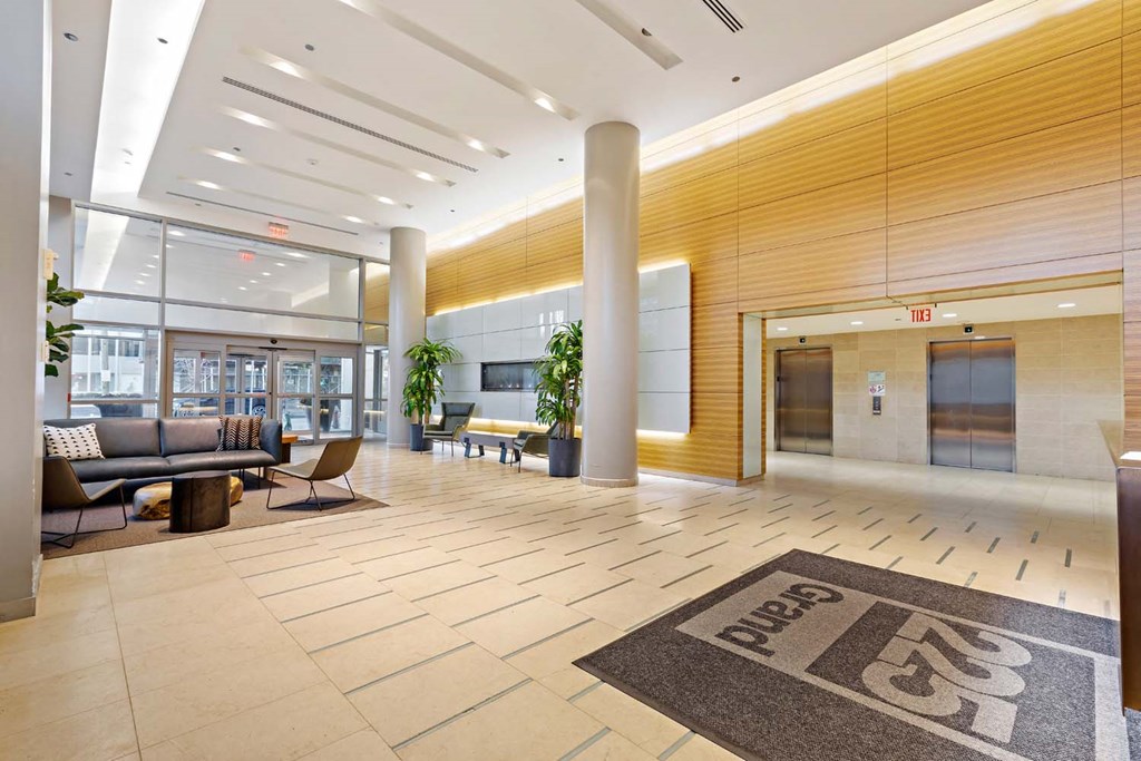 a lobby with couches and chairs and a rug on the floor