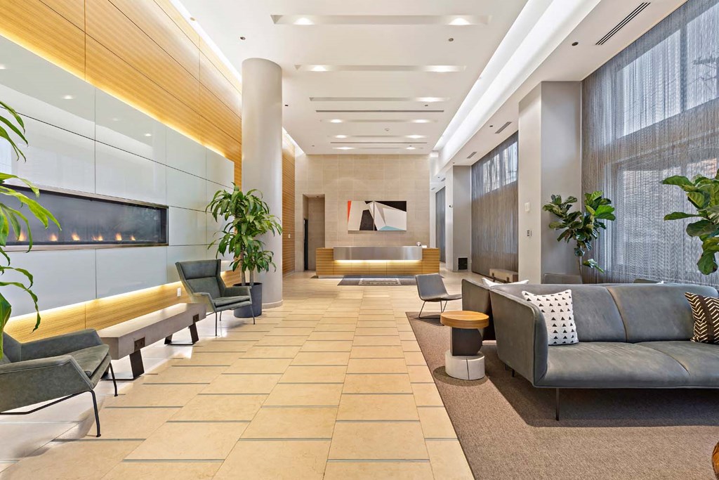 a lobby with couches and chairs and a table