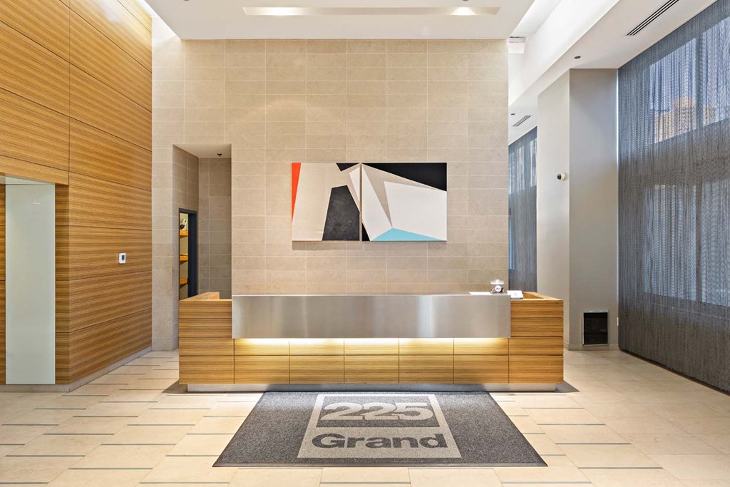 the lobby of a building with a reception desk and a painting