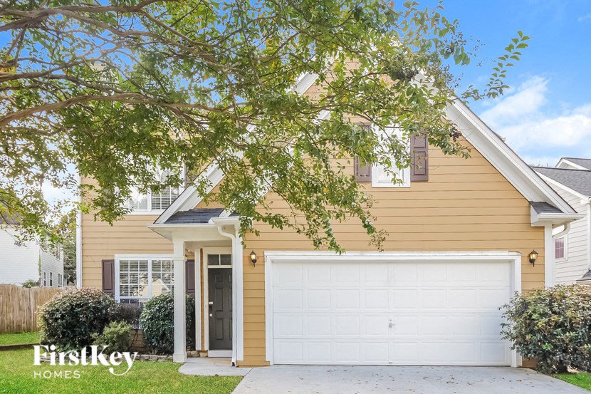 A house with a white garage door is for sale.