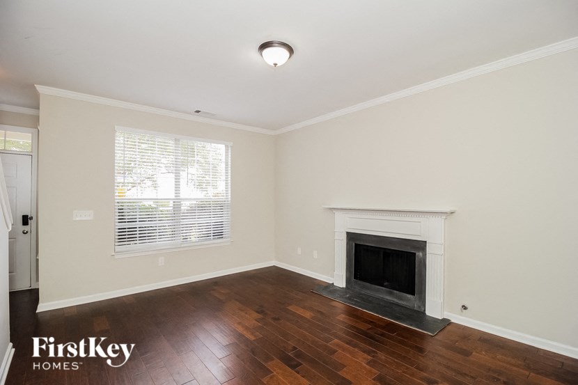A room with a fireplace and wooden floors.