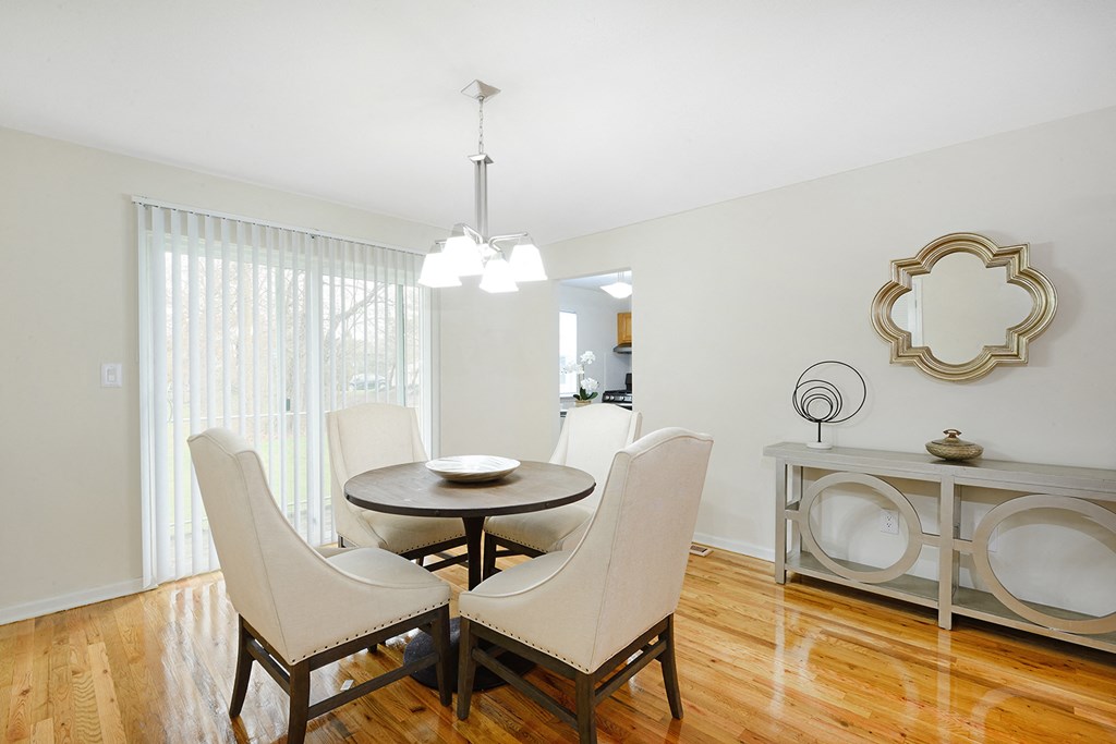 a dining room with a table and chairs and a chandelier