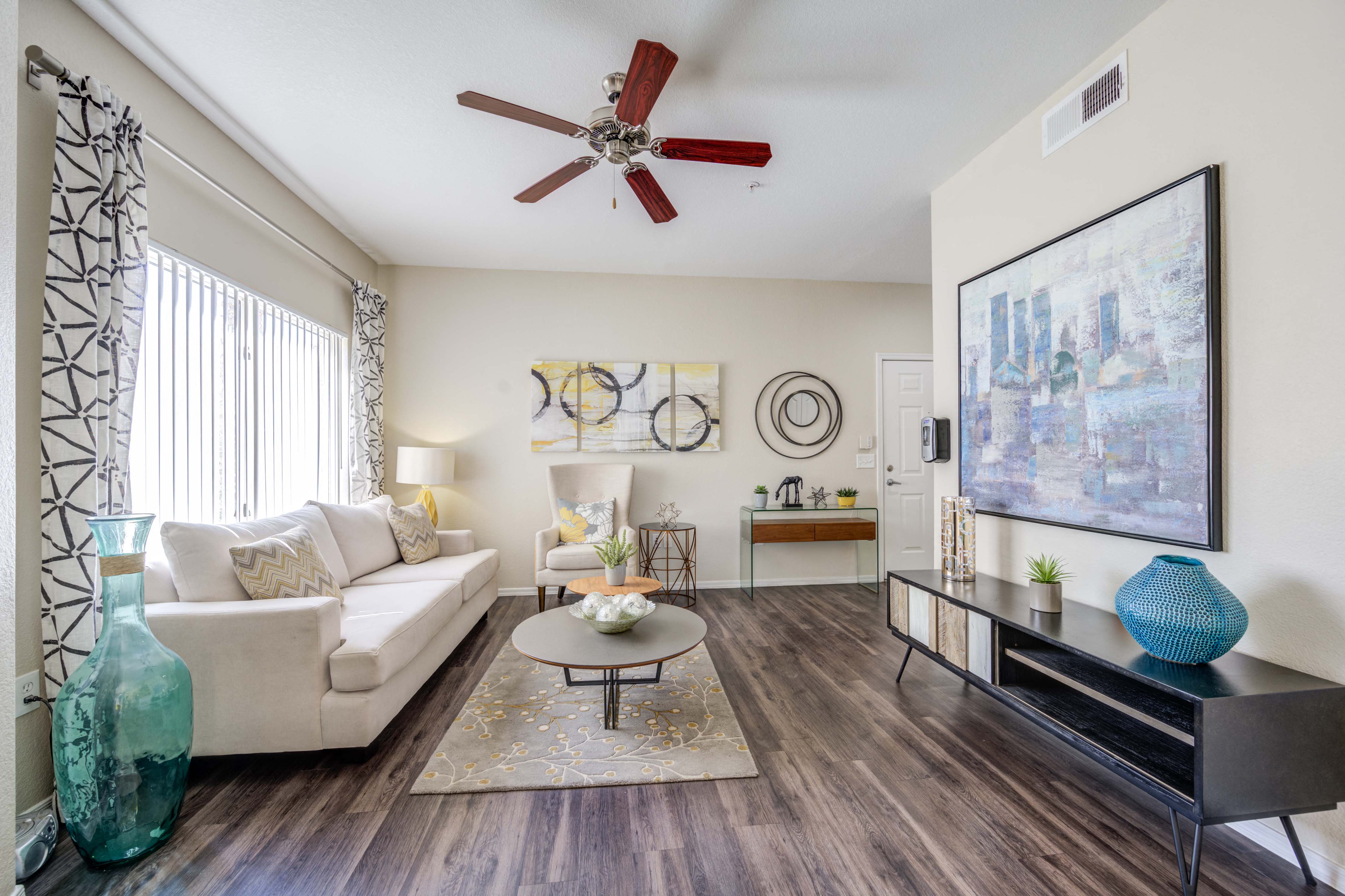 a living room with a couch and a ceiling fan