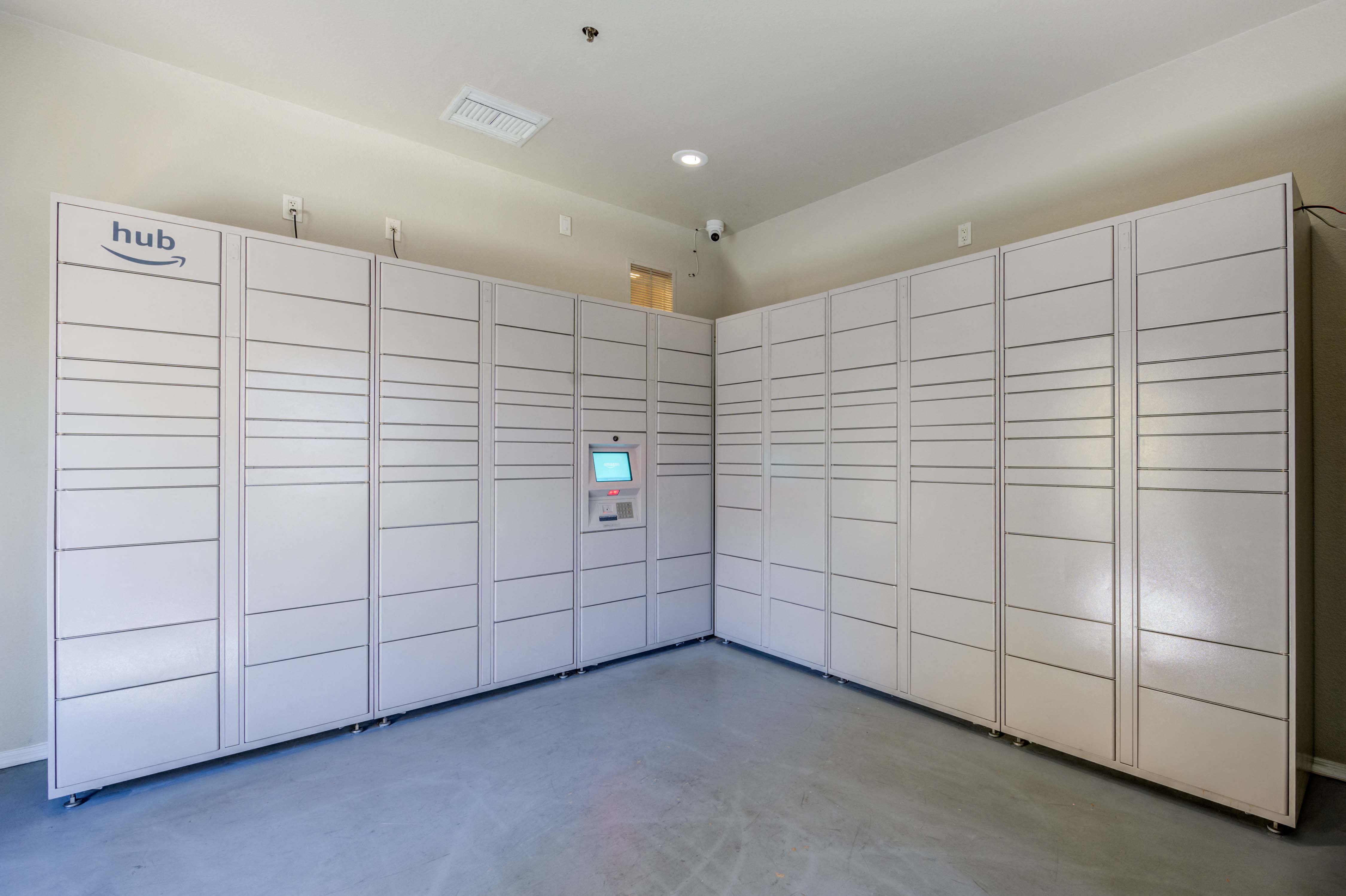 a bunch of white storage lockers in a room