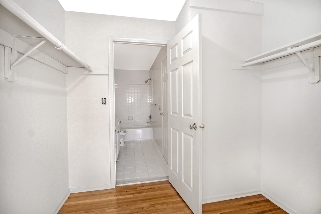 an empty room with a door open to a bathroom
