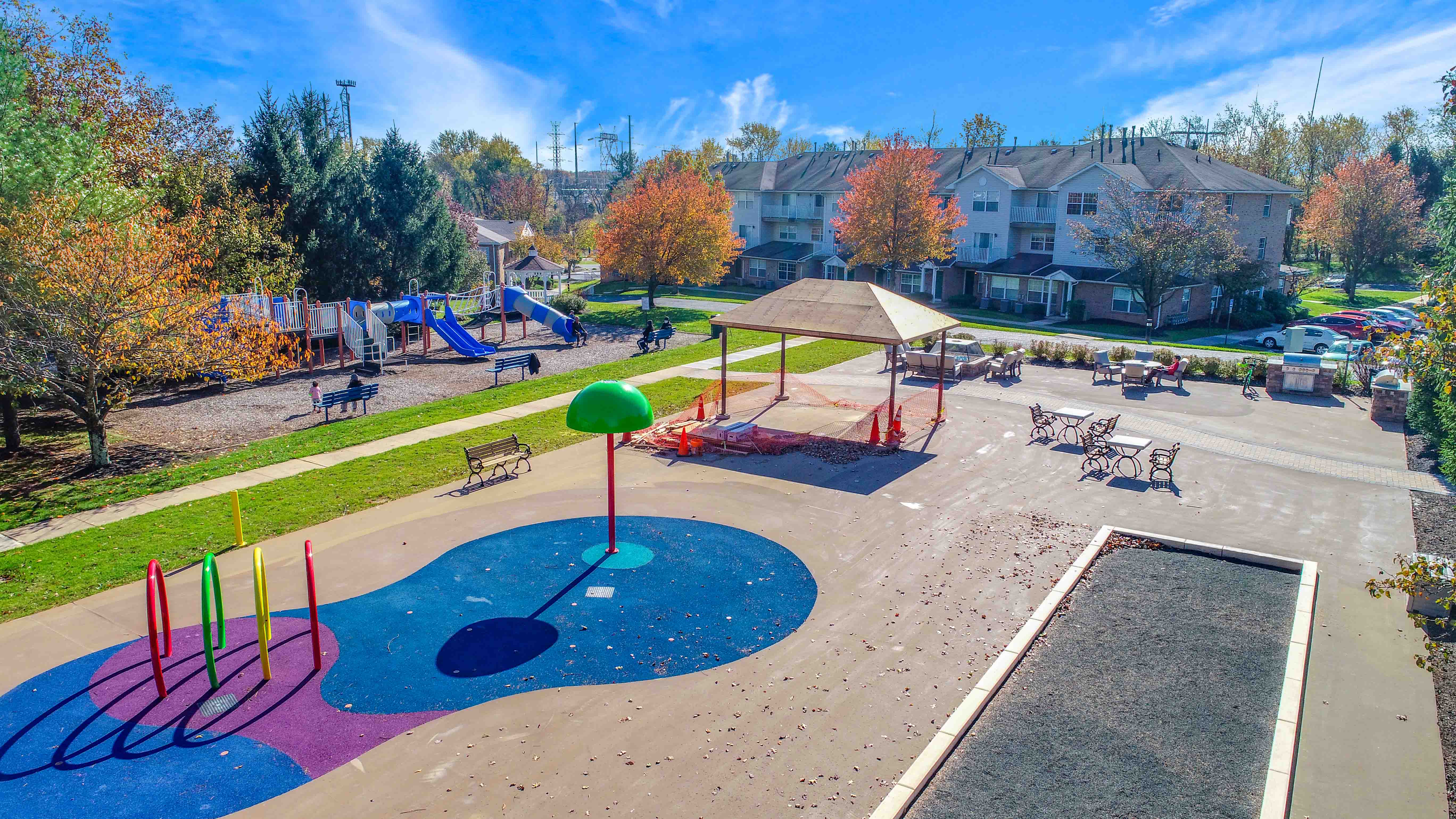 a playground at a park with houses in the background