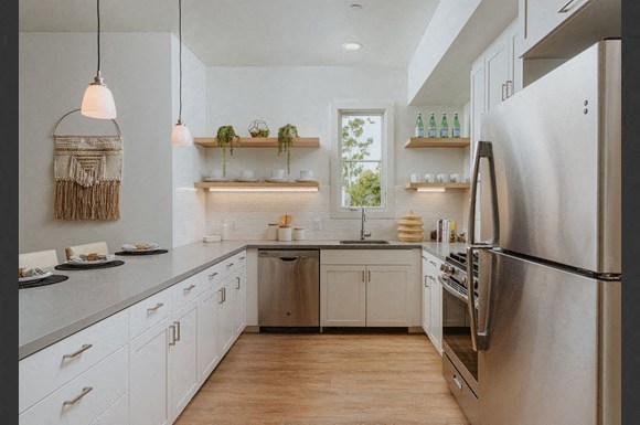 a kitchen with stainless steel appliances and white cabinets