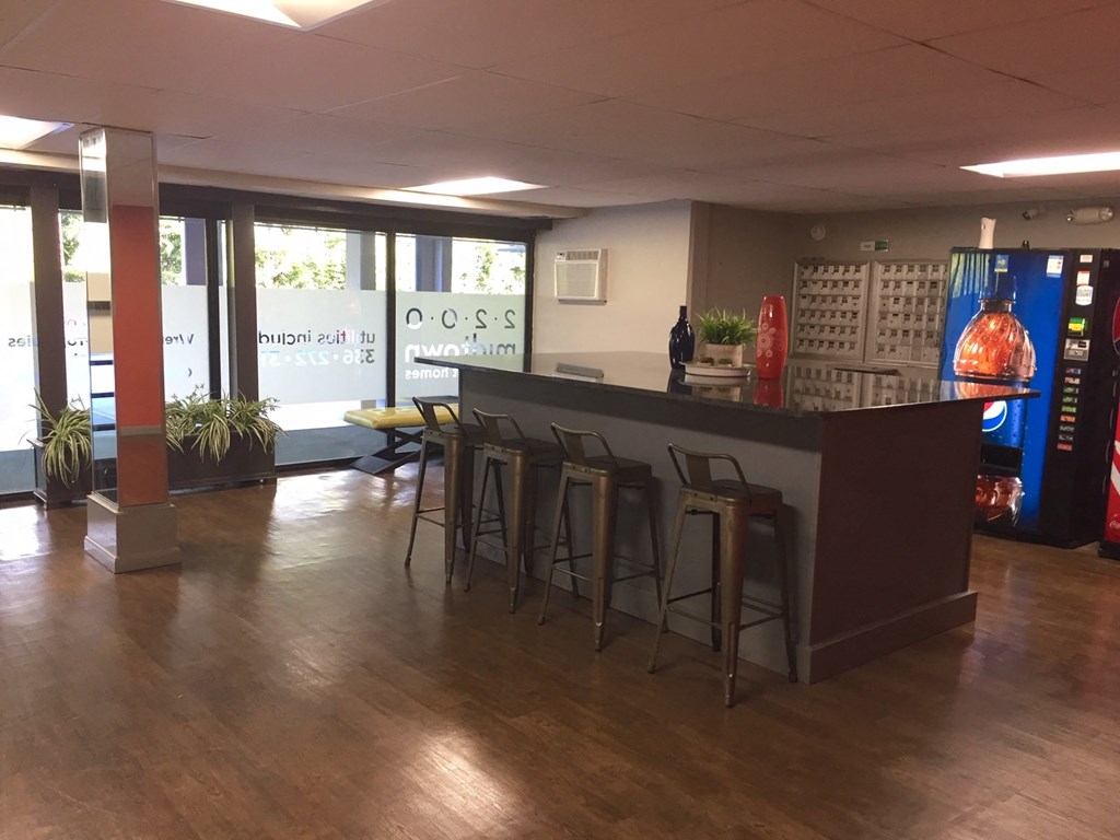 the lobby of a restaurant with a bar and stools