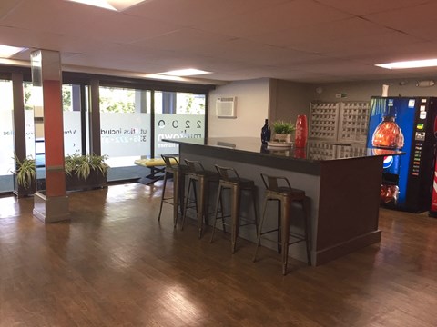 the lobby of a restaurant with a bar and stools