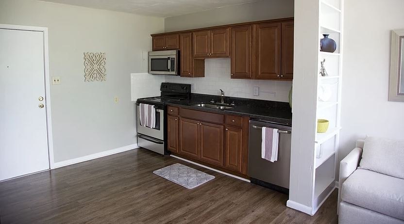 a kitchen with a stove and a sink and a microwave