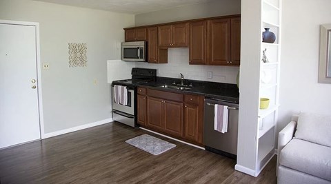 a kitchen with a stove and a sink and a microwave
