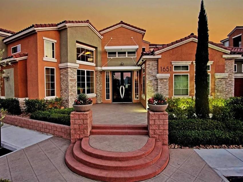 the front of a house with a large staircase in front of it