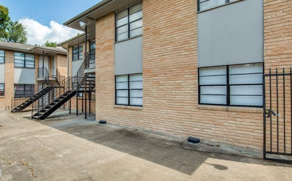 a brick apartment building with stairs and a brick facade