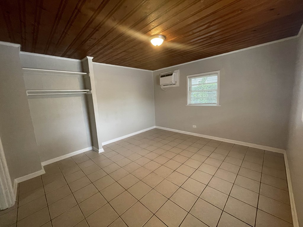 a room with a tiled floor and a closet