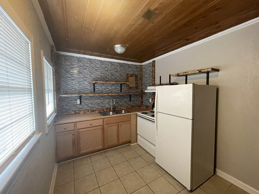 a kitchen with a sink and a refrigerator