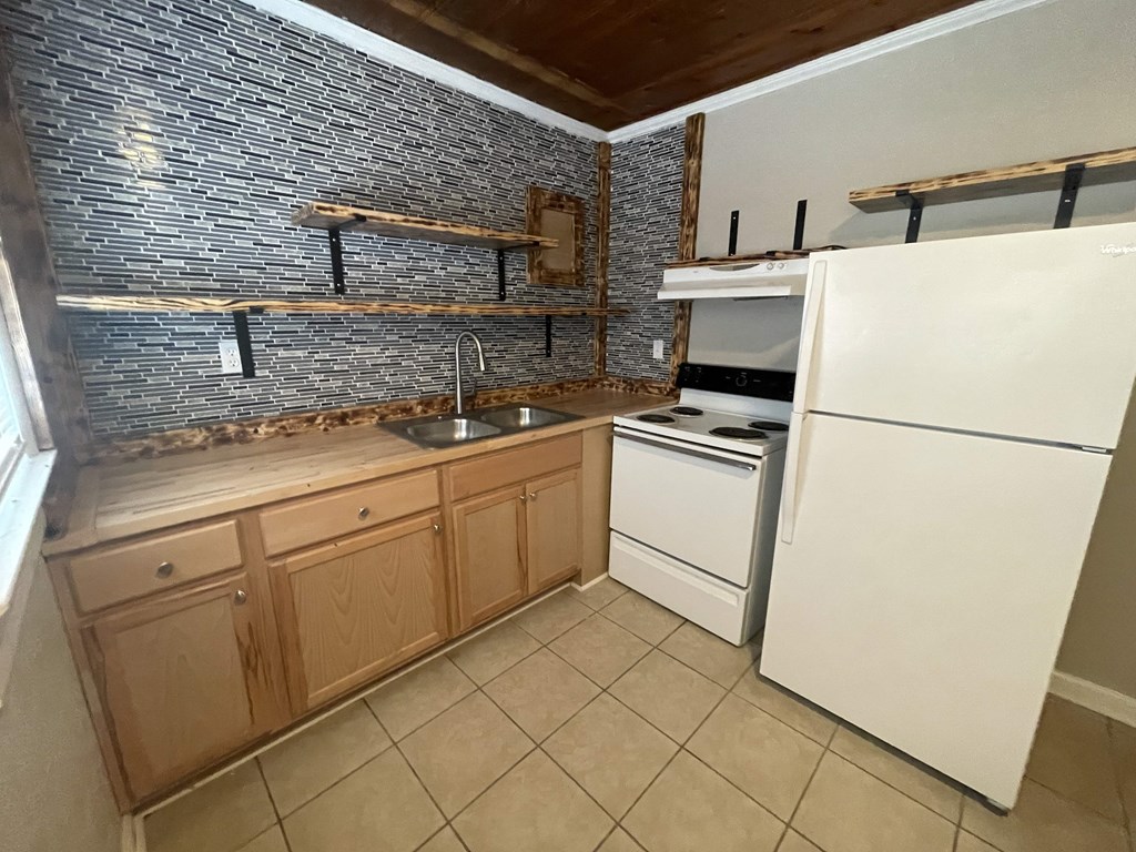 a kitchen with a sink and a refrigerator
