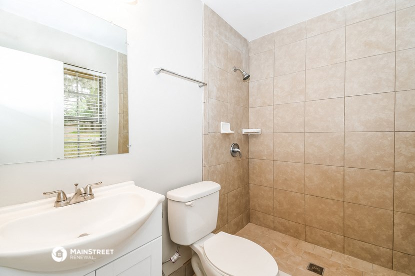 a bathroom with a sink toilet and a mirror