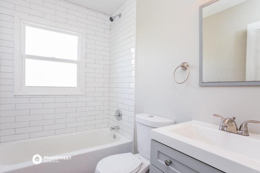 a white bathroom with a sink toilet and tub