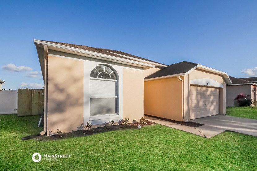 the exterior of a home with a shed and a garage