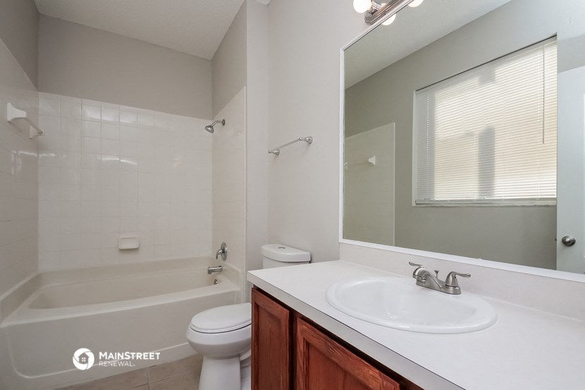 a bathroom with a sink toilet and a bath tub