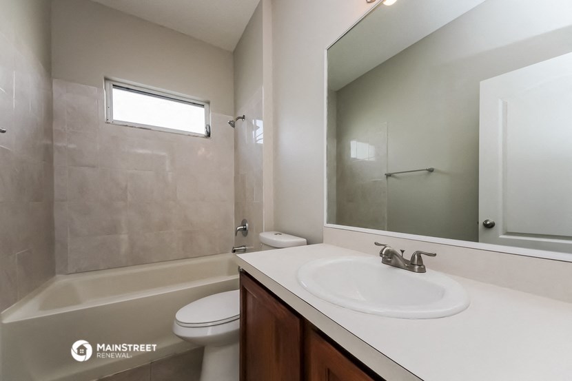 a bathroom with a sink and a mirror and a shower