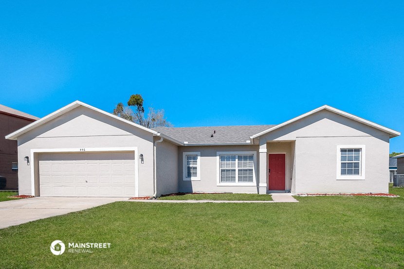a white house with a lawn in front of it
