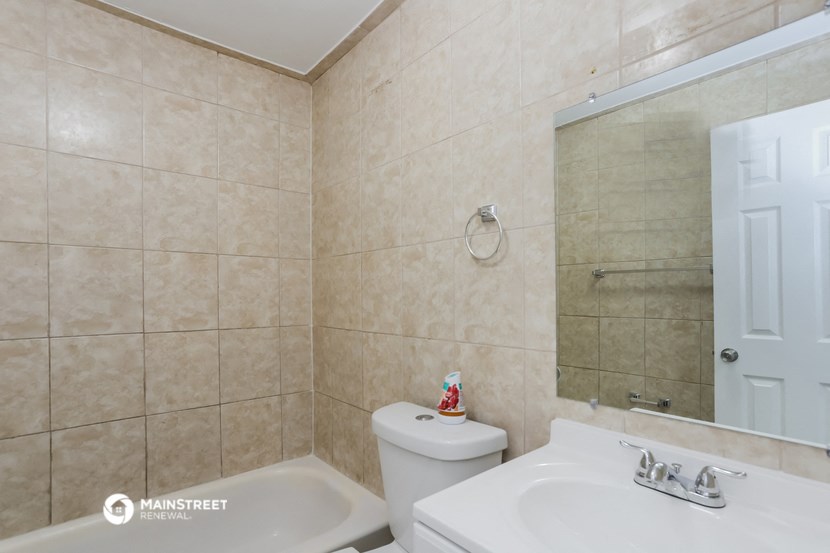 a bathroom with a sink toilet and a mirror