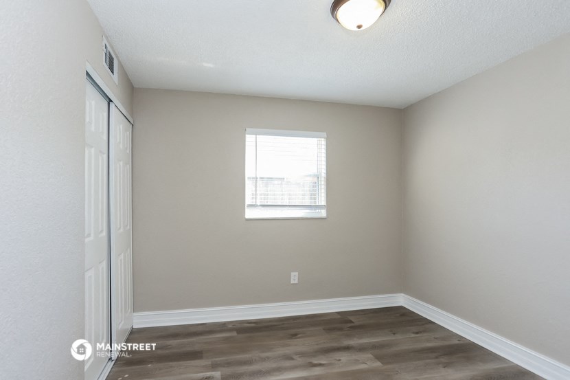the interior of a room with white walls and a window
