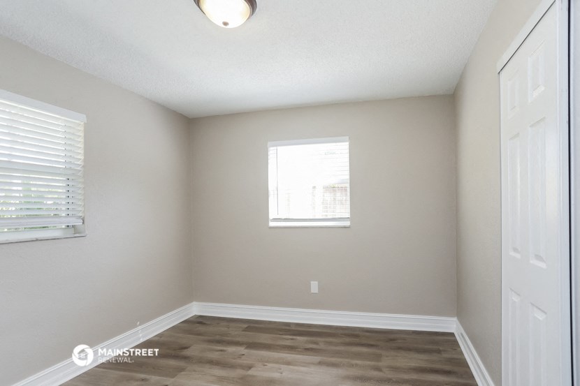 an empty room with white walls and a window