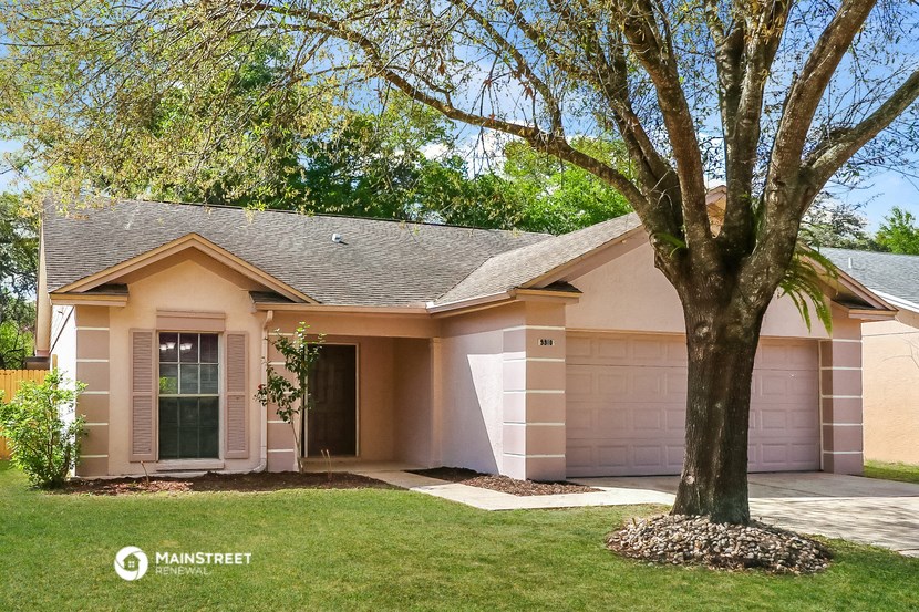 a pink house with a tree in front of it