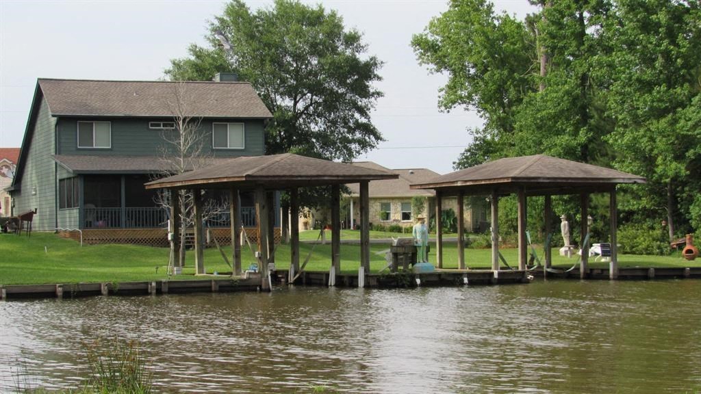 a house on a river with a boat dock