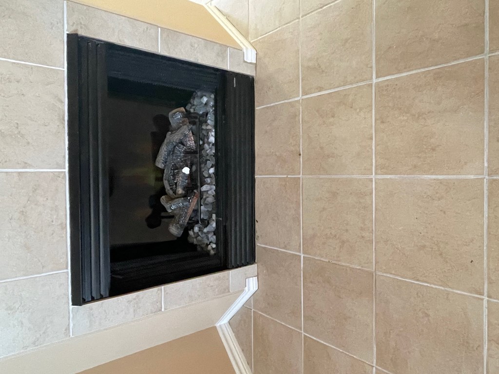 a fireplace in a bathroom with tiled walls