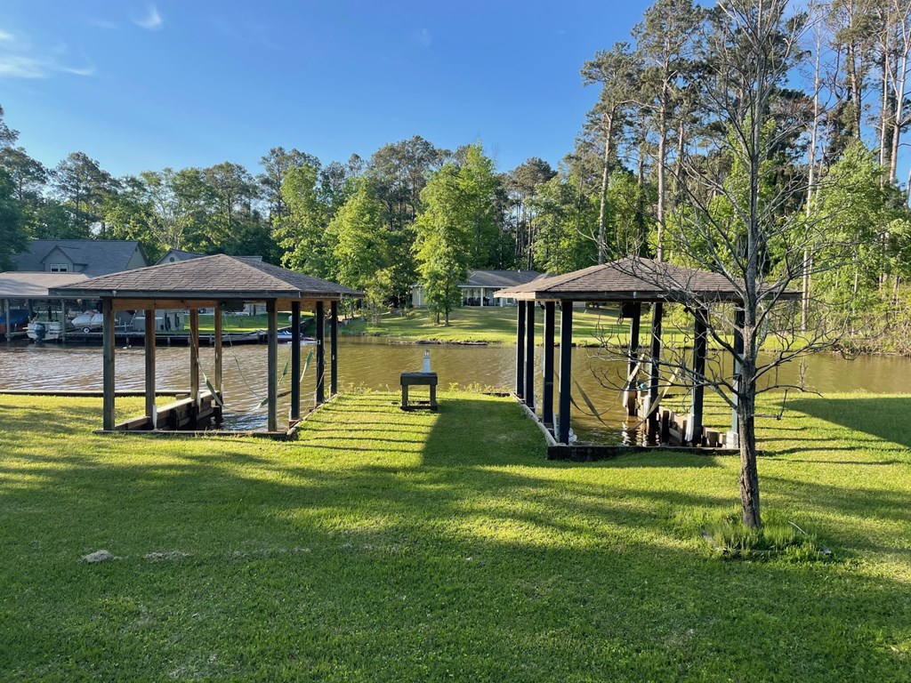 a park with gazebos near a body of water