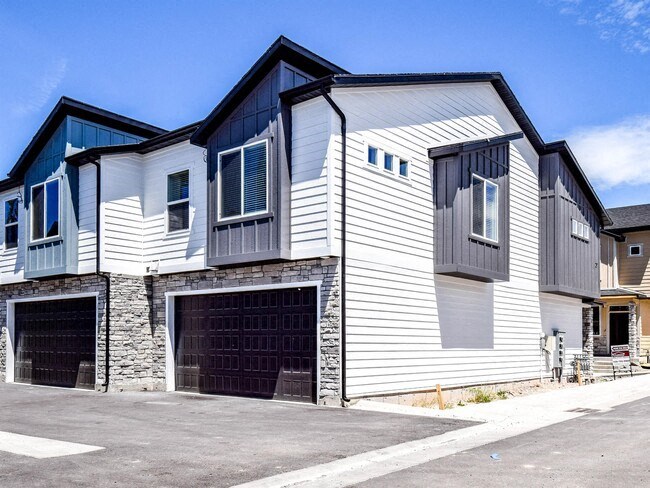 a white house with a garage and a blue sky