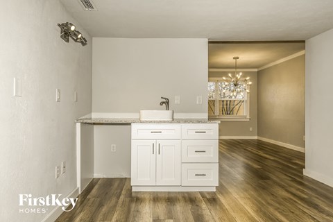 a kitchen and living room with a sink and a counter