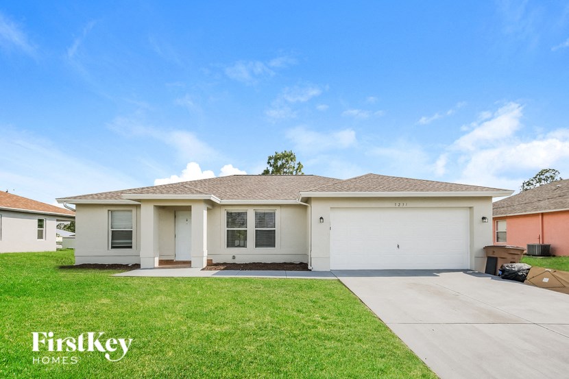 A two-story house with a garage is for sale.