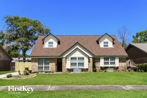 front view of a home with green grass and a blue sky