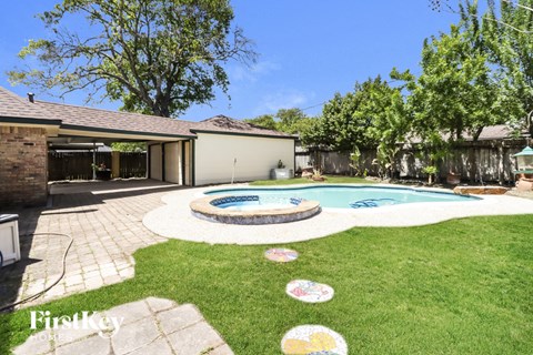 a backyard with a pool and a house
