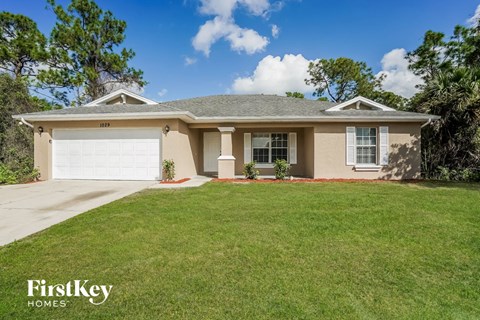 A house with a garage door numbered 1022 is for sale.