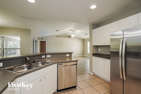A kitchen with a stainless steel refrigerator and a dishwasher.