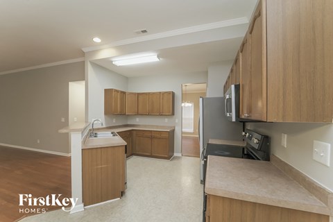 A kitchen with wooden cabinets and a countertop.