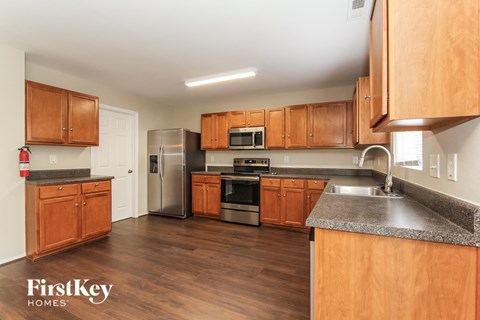a kitchen with wooden cabinets and stainless steel appliances