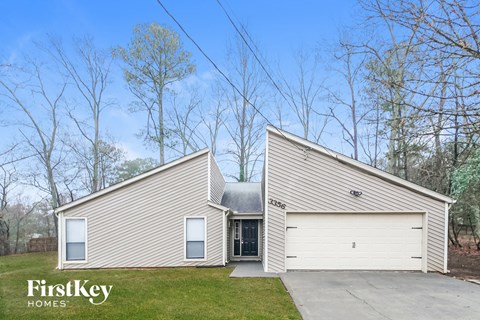 the front of a house and a garage with a driveway