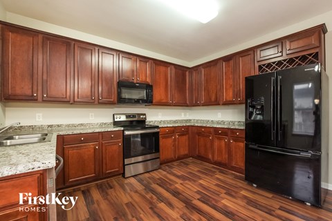 a kitchen with wooden cabinets and black appliances