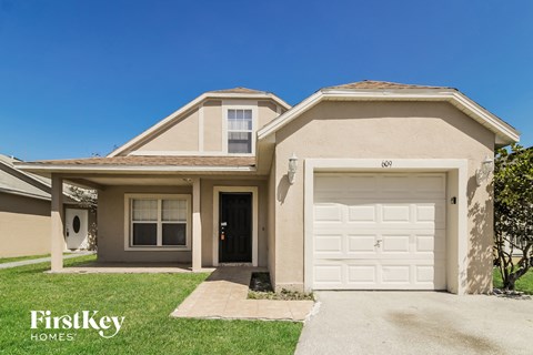a beige house with a white garage door