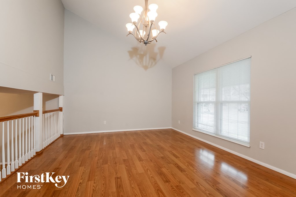A room with wooden floors and a chandelier.