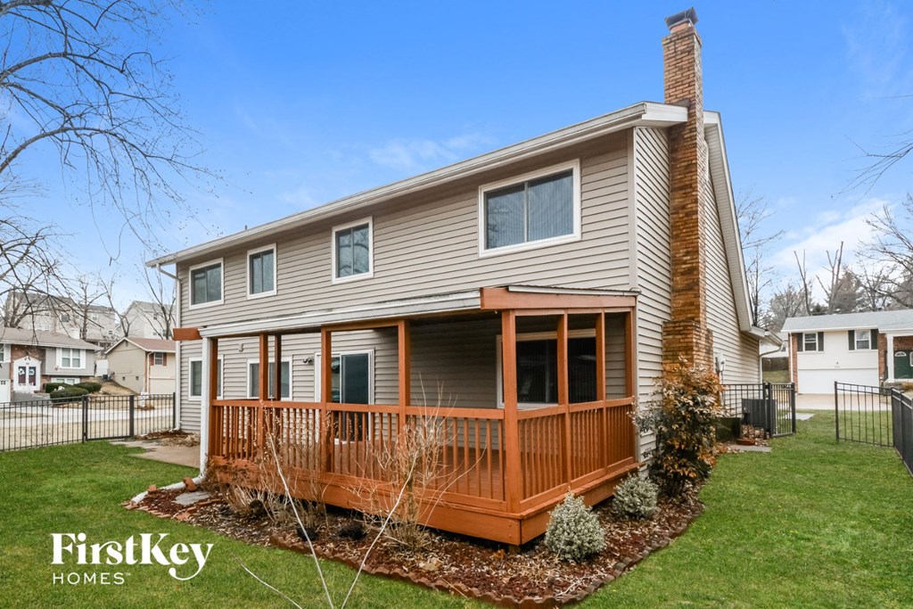 A house with a brown deck and a brown roof.