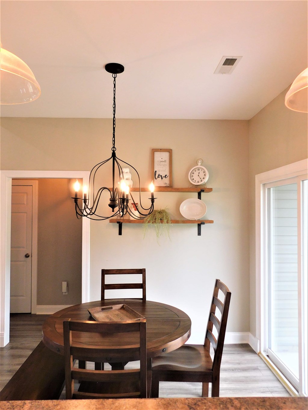 A dining room with a round table and chairs.