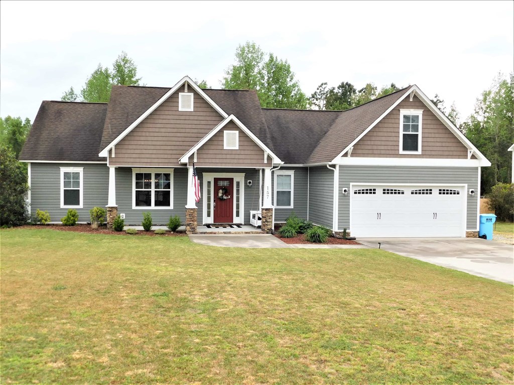 A house with a red door and a flag on the front porch.