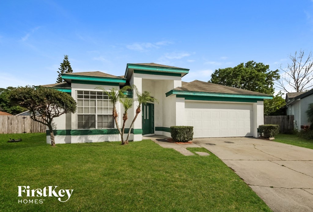 a home with a fish statue in the front yard